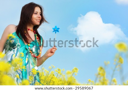 beautiful young happy woman on rapeseed field in bloom