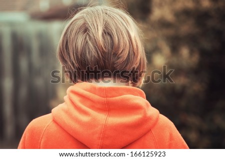 back view of girl with jacket hood outside