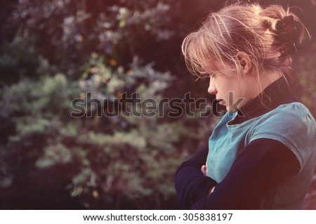 sad girl outdoors in sunlight