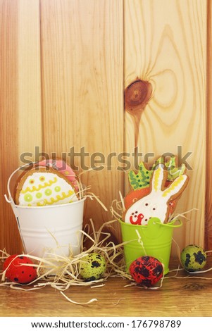 Easter funny cookies and eggs over wood background