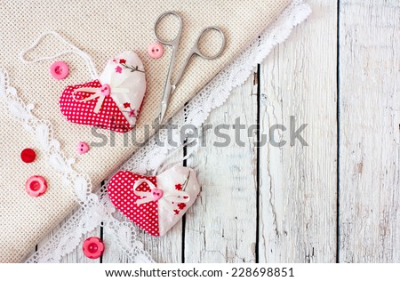 Vintage wood background with scrapbook elements- hearts, buttons, scissors, laces