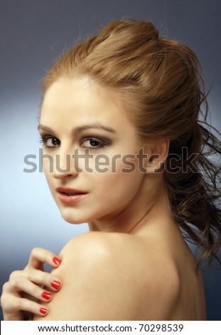 Sensual red hair woman studio shot, head and shoulders, looking at the camera