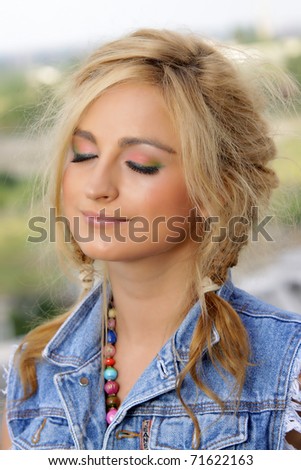 Happy blonde woman head and shoulders with eyes closed. Make up shot