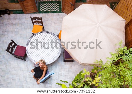 happy woman in arabic house with cup of tea