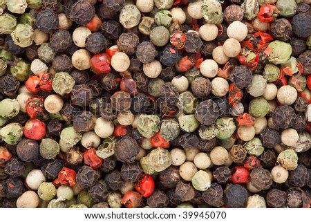 Mix of four peppers in peas. Black, white, red and rose peppers