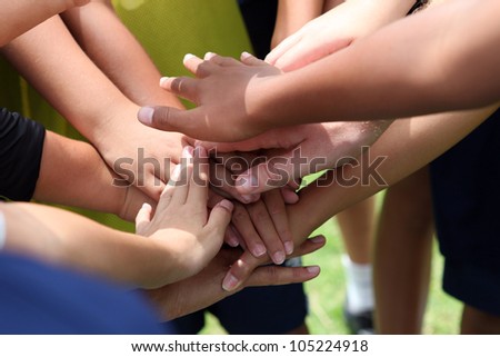 group of young people\'s hands