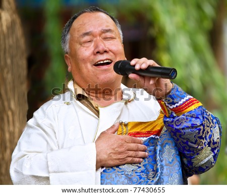 BEIJING- MAY 16: An old singer from Menggu race of China performs with the traditional songs from Menggu race in the 