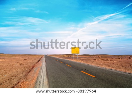 An image of desert traffic desert road in China, with a banner aside for abstract concept