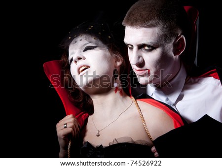 a vampire biting a young woman from behind