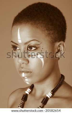 Portrait of African American woman wearing original tribal themed face-paint and necklace (toned)
