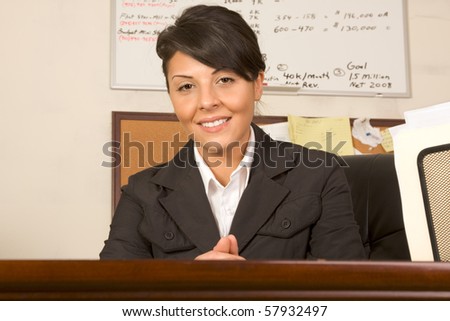 Businesswoman by desk in her office welcome visitor or business partner