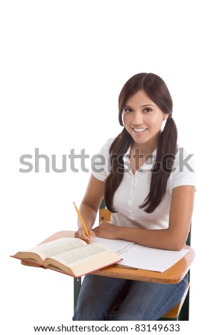Latina High school or college female student sitting by the desk at class doing homework.