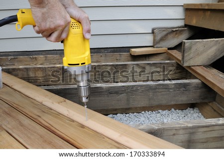 Worker Using Electric Drill