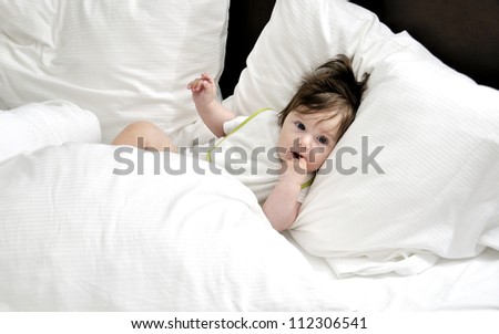 Baby in bed with three pillows