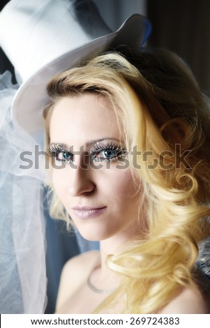 Fashion stylish beauty bride portrait with white long curly hair and hat
