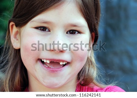 happy smiling toothless little girl