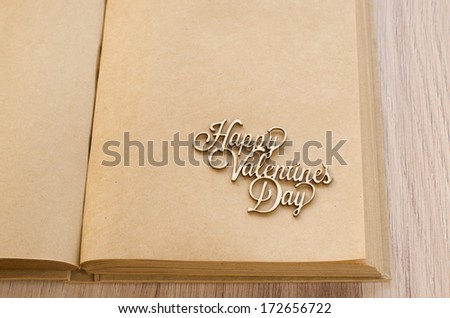one empty page of diary of craft paper with handmade wooden St. Valentine's greetings text