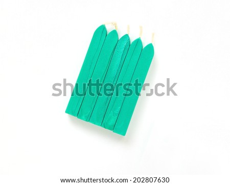turquoise sealing wax candles isolated on white background with shadow