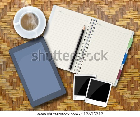 Office objects , notepad, tablet computer, photo frames, coffee cup on background.