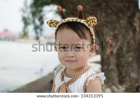 Cute asian girl with hair band portrait.