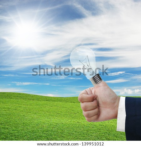 art work of light bulb with on the thumb with nature background