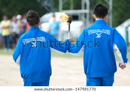 KO SAMUI,SURAT THANI - JULY 18 : Unidentified Thai students 4 - 7 years old with light torch in ceremony uniform during sport parade on July 18, 2012 in ko samui, Surat Thani, Thailand.