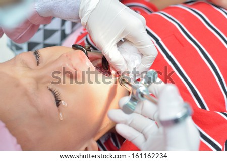 Young asian boy during anethetic injection before dental extraction.