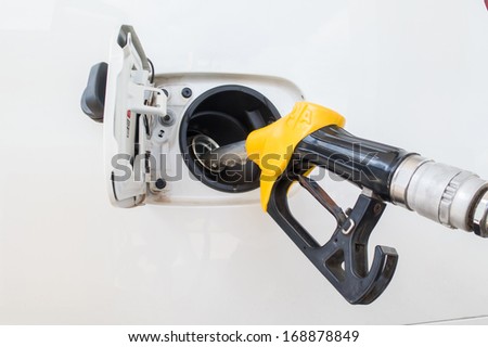 Close-up fuel nozzle. Fill up fuel at gas station.