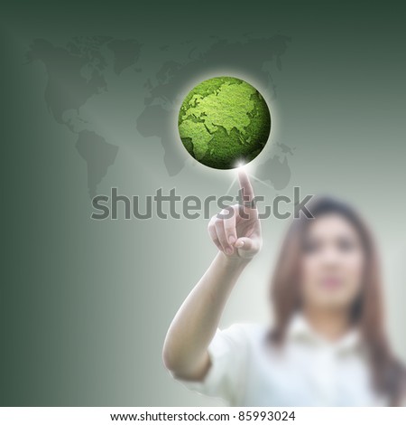 business woman pointing on green globe on attractive background.