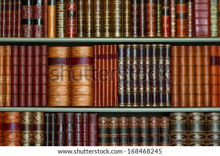 Old library of vintage hard cover books on shelves