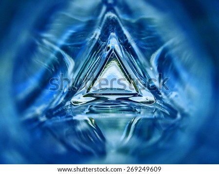 Abstract image of the inside of a triangle glass bottle blue color background