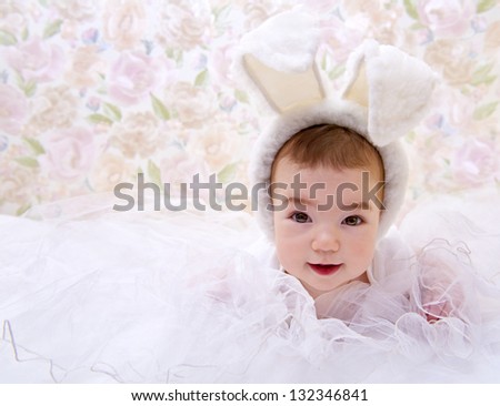 Happy baby in white rabbit costume