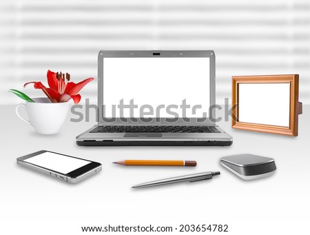 Blank screen notebook, smartphone and frame in the office