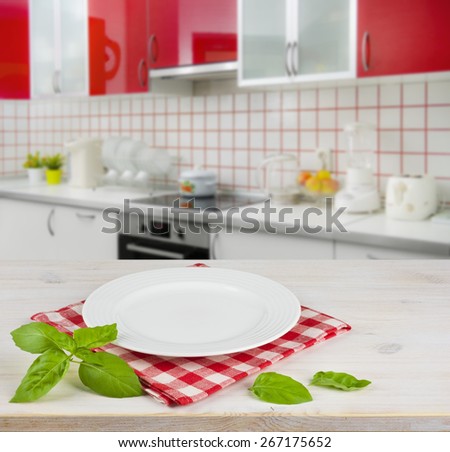White plate on table placemat over modern kitchen interior background
