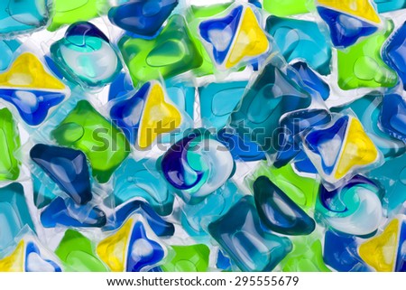 Background of various capsules with laundry detergent and dishwasher soap
