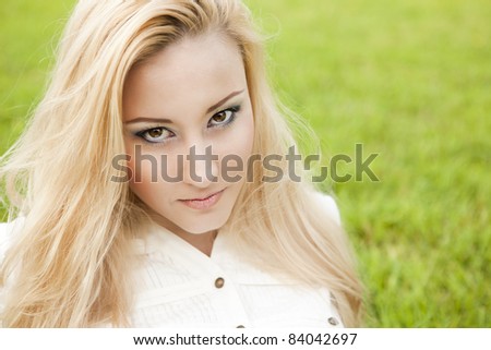 outside portrait of beautiful young blond woman on natural background