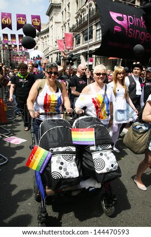 LONDON - JUNE 29: People, with children, take part in London\'s Gay Pride on June 29, 2013 in London, UK, estimated 25,000 people took part in the march, Parade to support gay rights.