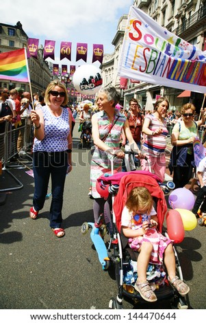 LONDON - JUNE 29: People, with children, take part in London\'s Gay Pride on June 29, 2013 in London, UK, estimated 25,000 people took part in the march, Parade to support gay rights.