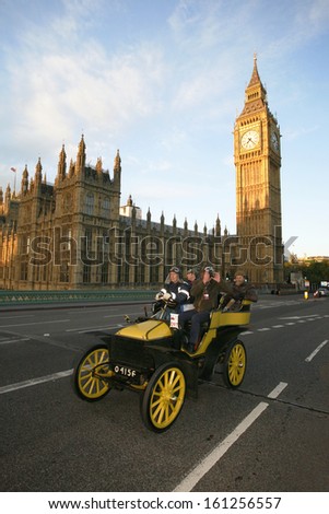 LONDON - NOV 03: London to Brighton Veteran Car Run participants passing Westminster Bridge, Big Ben in the background, on November 03, 2013 in London, UK. Event starts at 7:00am in Hyde Park, London