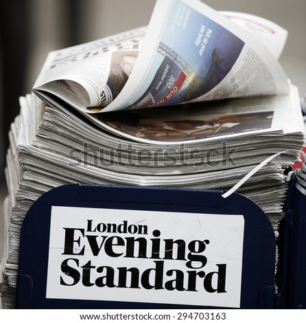 LONDON - MARCH 4: A pile of popular Evening Standard, free daily newspaper, evening tabloid paper, made available to afternoon commuters on March 4, 2013, London, UK.