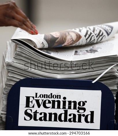 LONDON - MARCH 4: A pile of popular Evening Standard, free daily newspaper, evening tabloid paper, made available to afternoon commuters on March 4, 2013, London, UK.