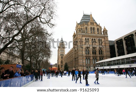 LONDON - JANUARY 08: Ice-skating people beating the winter cold at the famous Natural History Museum\'s annual Ice Rink on January 08, 2011 in London, UK.
