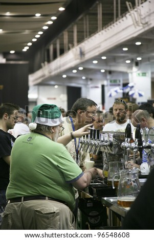 LONDON - AUG 05: Brewers of Great British Beer Festival, 2010, at Earls Court, Britain\'s biggest beer festival on Aug 05, 2010 in London, UK. Visitors can try wide range of real ales, ciders, perries.