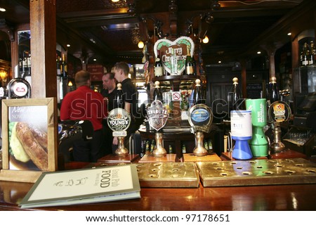 LONDON - AUG 30: Interior of pub, for drinking and socializing, focal point of the community, on Aug 30, 2010, London, UK. Pub business, now about 53,500 pubs in the UK, has been declining every year