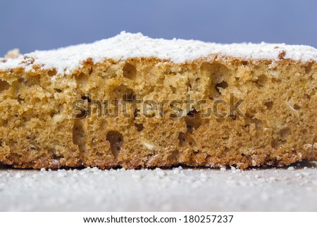 close-up of a honey cake in white powdered sugar
