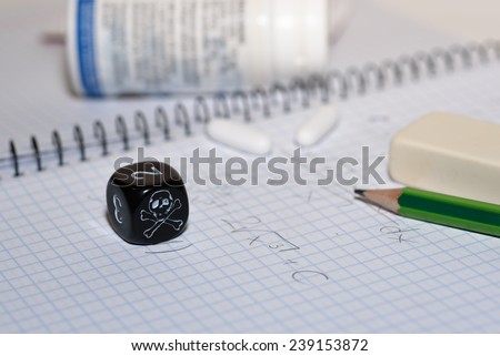 study place with painkillers in background and skull dice - stock photo