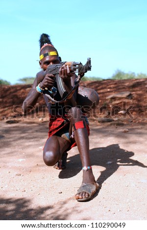 OMO VALLEY-JAN 26:Unidentified Hammer Man with gun in his hand Jan 26, 2012 in Omo Valley, Ethiopia.The ethnic groups in the Omo valley could disappear because of Gibe III hydroelectric dam.