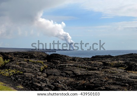 Fumes and smoke billow skyward as Kilauea dumps lava into the ocean on the coast of the Big Island of Hawaii.