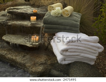 waterfall at spa with towels and candles