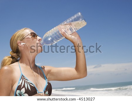attractive young woman is having a drink of water